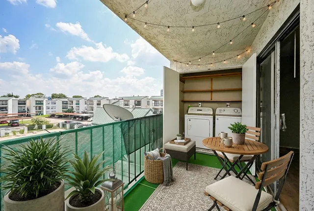 a balcony with furniture and potted plants