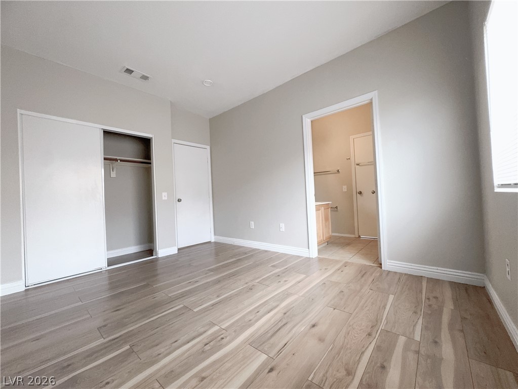 8725 West Flamingo Road, Unit 208 Las Vegas, NV 89147 - Photo 13 of 16 This spacious bedroom offers comfortable living with elegant flooring and a well-appointed bathroom access.