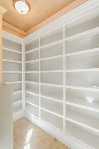 a view of walk in closet with empty racks