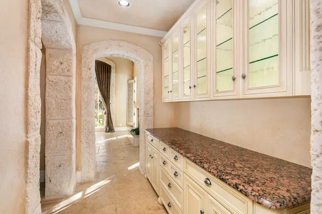 a view of a kitchen with granite countertop cabinets and a stove