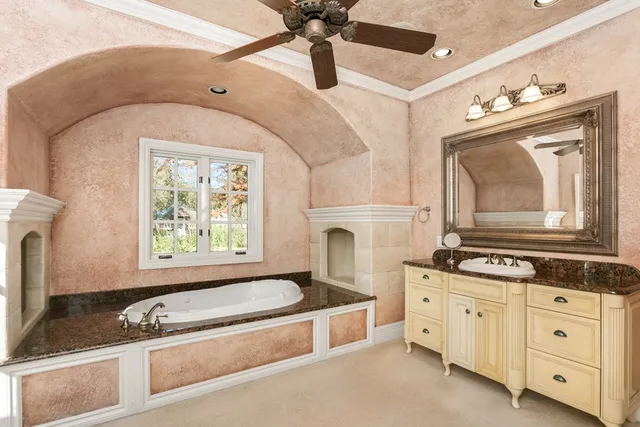 a bathroom with a granite countertop sink a vanity and a mirror