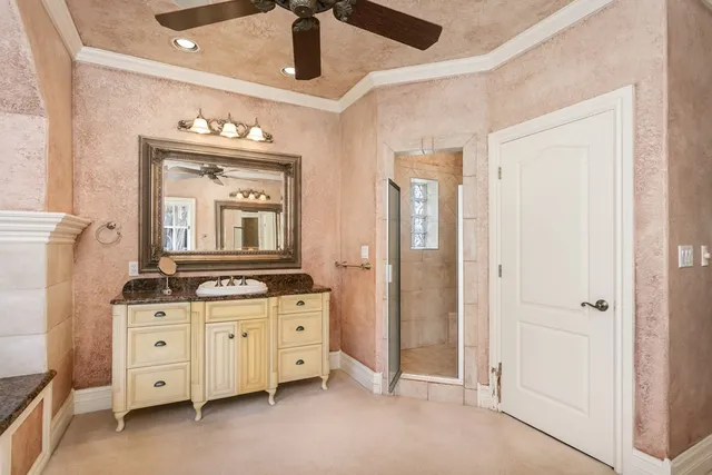 a spacious bathroom with a granite countertop sink mirror and vanity