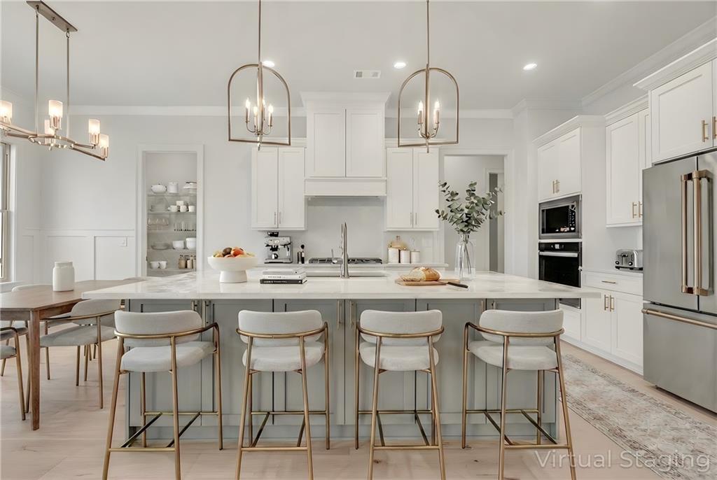 7054 Hammock Trail Gainesville, GA 30506 - Photo 13 of 72 a kitchen with stainless steel appliances a dining table chairs sink and cabinets