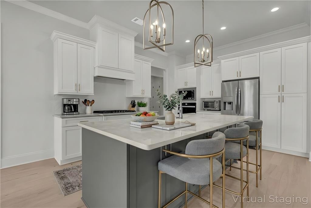 7054 Hammock Trail Gainesville, GA 30506 - Photo 18 of 72 a kitchen with stainless steel appliances a table chairs and a refrigerator