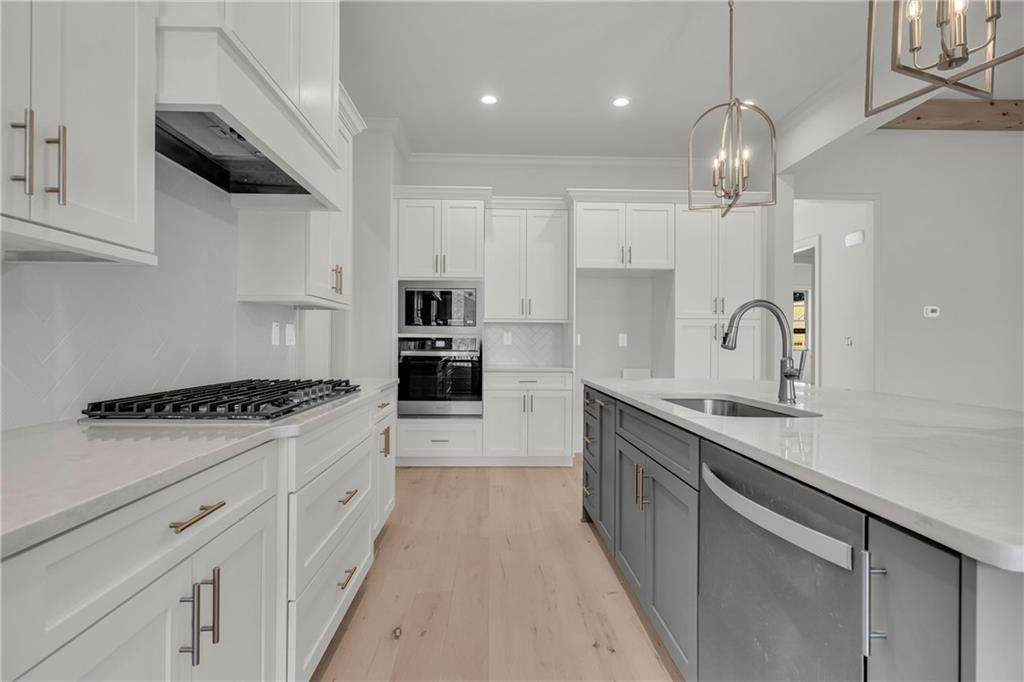 7054 Hammock Trail Gainesville, GA 30506 - Photo 20 of 72 a kitchen with kitchen island granite countertop a sink stainless steel appliances and cabinets