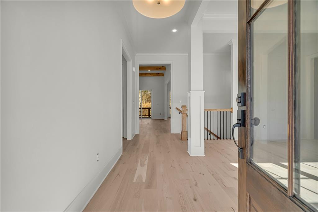 7054 Hammock Trail Gainesville, GA 30506 - Photo 3 of 72 a view of a hallway with wooden floor and a bathroom