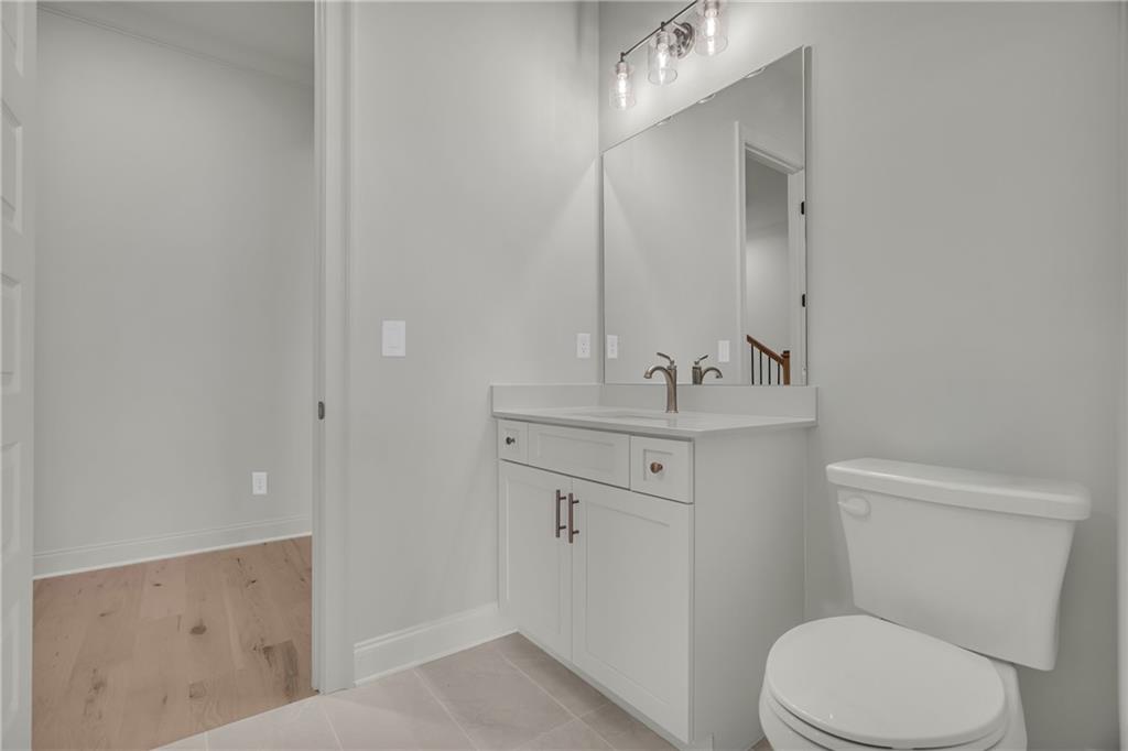 7054 Hammock Trail Gainesville, GA 30506 - Photo 37 of 72 a bathroom with a sink a toilet a mirror and vanity
