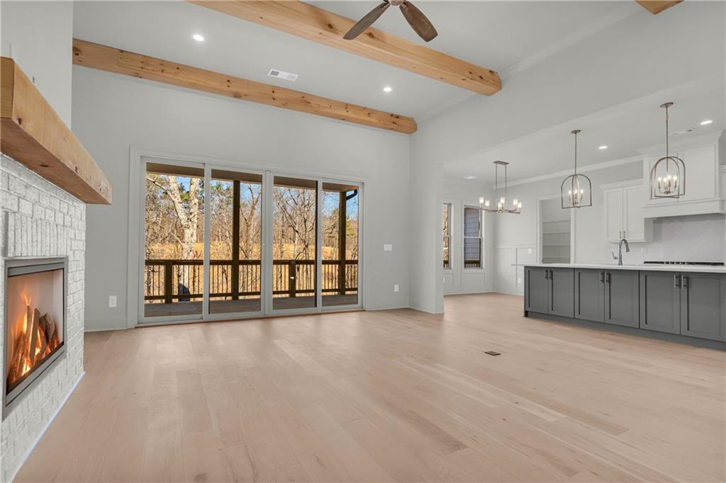 7054 Hammock Trail Gainesville, GA 30506 - Photo 9 of 72 a view of an empty room with a fireplace and a window