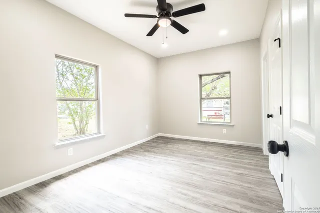 wooden floor in an empty room with a window