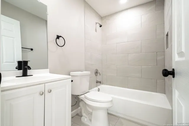 a bathroom with a sink a toilet and a bathtub