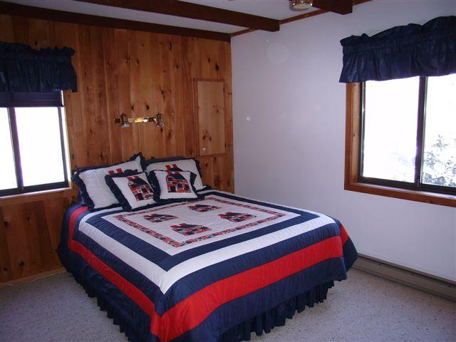 328 Bonny Rigg Hill Road Becket, MA 01223 - Photo 8 of 9 a bed sitting in a bedroom next to a window