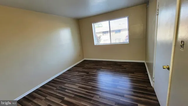 a view of an empty room and wooden floor