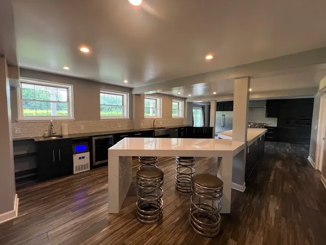 a kitchen with stainless steel appliances a refrigerator and a stove top oven