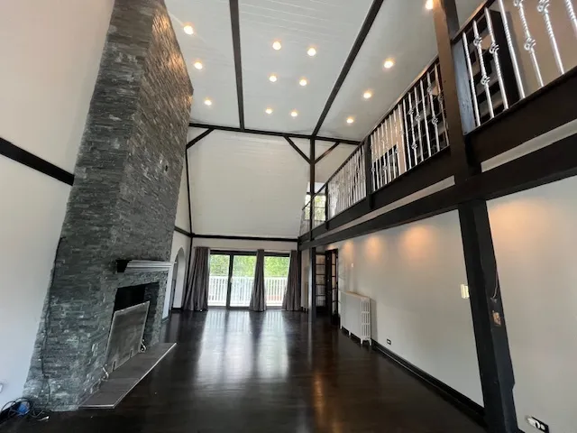 wooden floor in an empty room with a window