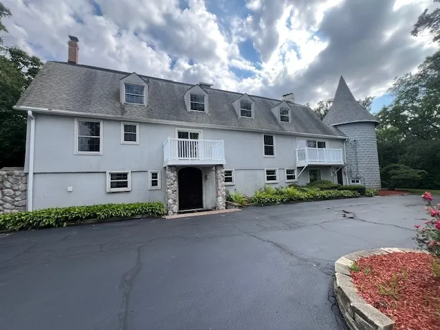 a view of a house with a yard and sitting area