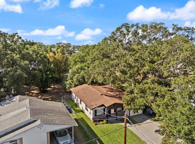 an aerial view of a house with a yard