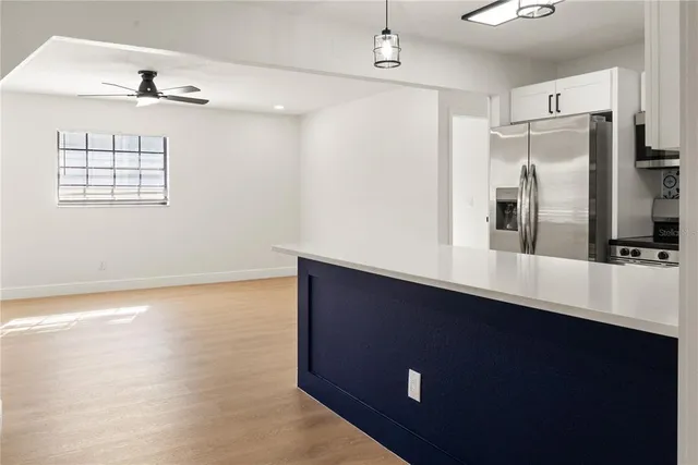 a kitchen with a refrigerator and a sink