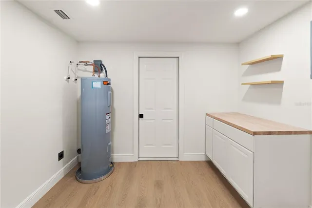 an empty room with fan and windows