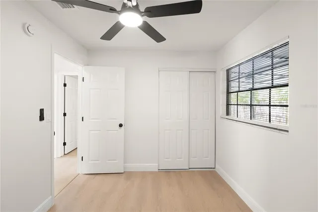 a view of empty room with wooden floor