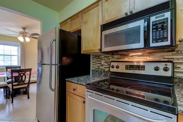 a kitchen with appliances and a microwave