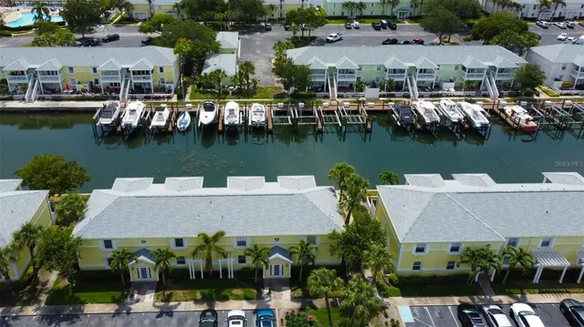 an aerial view of houses with yard and lake view