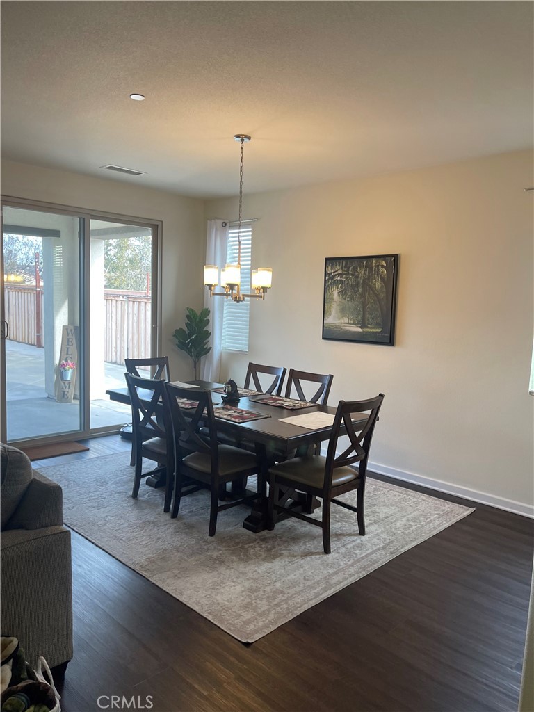 29192 Jacaranda Lake Elsinore, CA 92530 - Photo 5 of 7 a view of a dining room with furniture wooden floor and chandelier