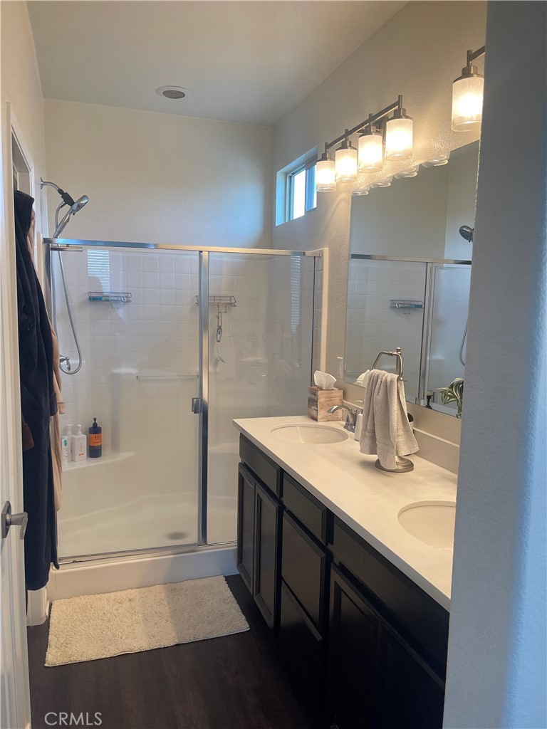 29192 Jacaranda Lake Elsinore, CA 92530 - Photo 7 of 7 a bathroom with a granite countertop sink mirror and a shower