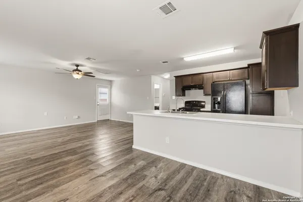 a view of kitchen with cabinets microwave and stove