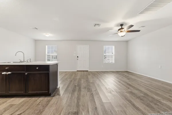 a view of a room with a sink and wooden floor