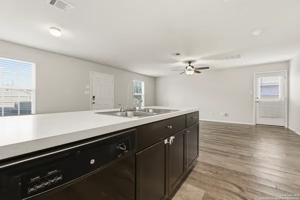 a view of kitchen with stainless steel appliances a sink and a refrigerator