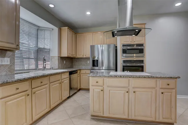 a kitchen with appliances cabinets and a sink