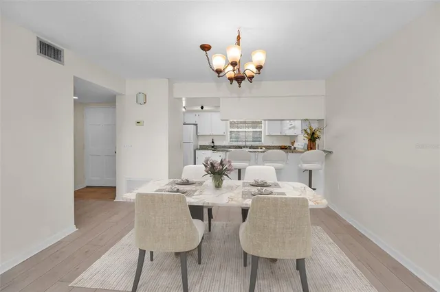 a kitchen with granite countertop white cabinets sink and stainless steel appliances