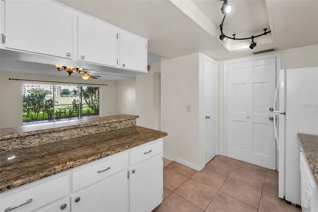 a kitchen with a sink cabinets and window