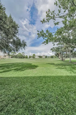 a view of a green field with wooden fence