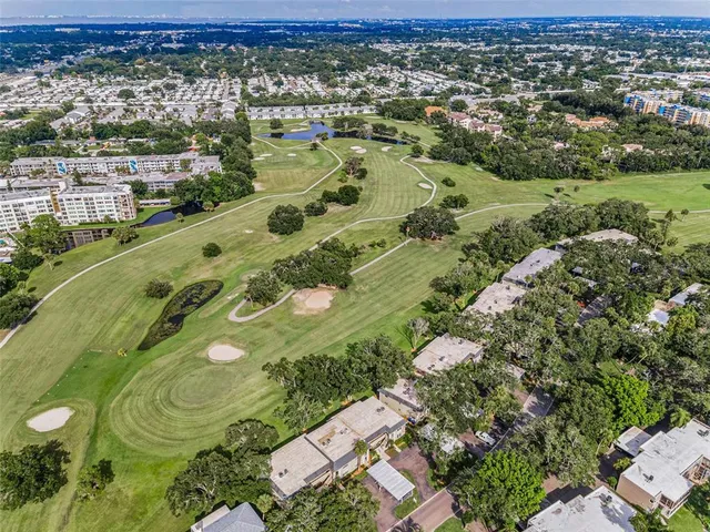 an aerial view of a houses with a lake