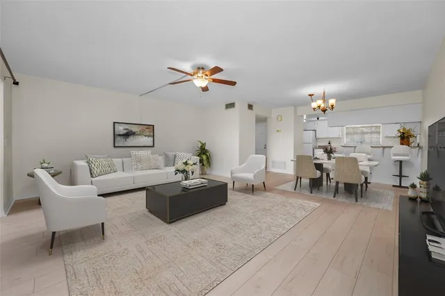 a view of a dining room with furniture a chandelier and wooden floor