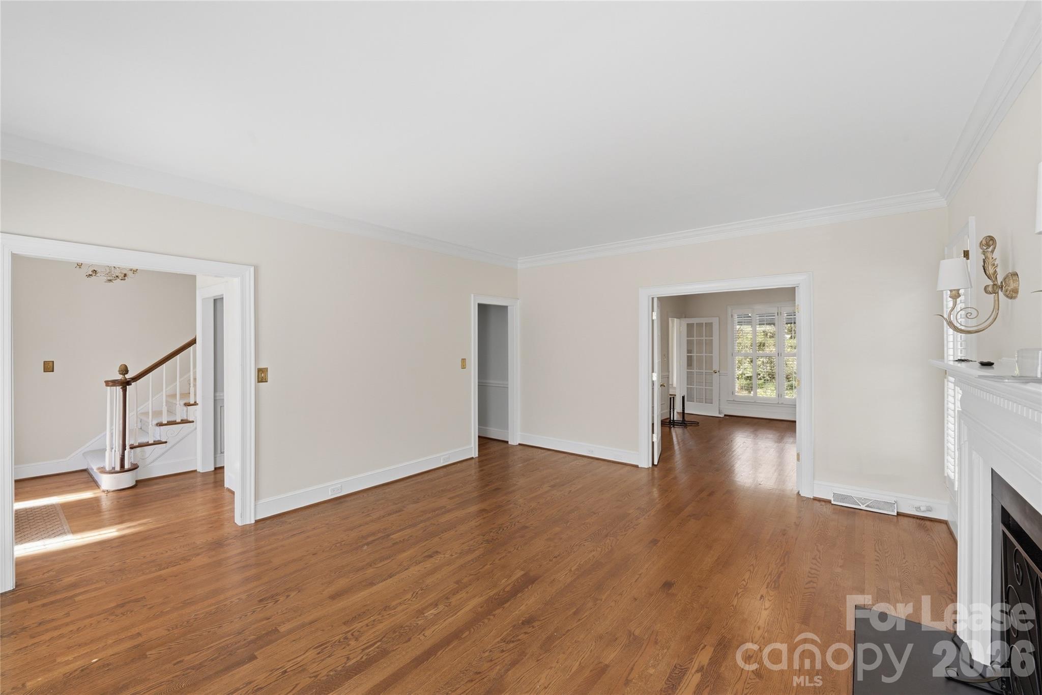 5906 Sharon Hills Road Charlotte, NC 28210 - Photo 10 of 30 a view of empty room with wooden floor and fan