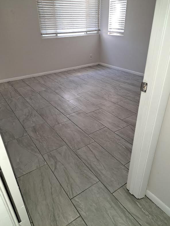701 Lyons Road, Unit 13208 Coconut Creek, FL 33063 - Photo 13 of 31 a view of an empty room with wooden floor and a window