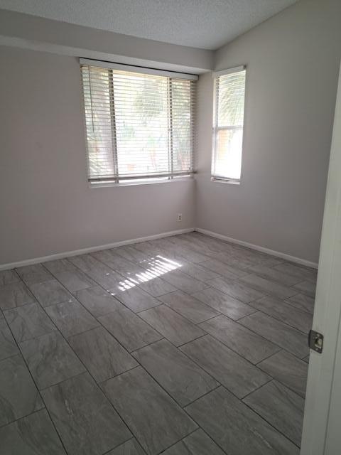 701 Lyons Road, Unit 13208 Coconut Creek, FL 33063 - Photo 14 of 31 an empty room with windows