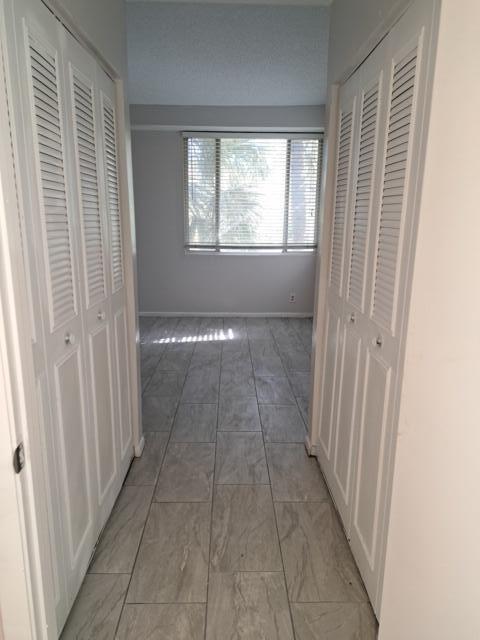 701 Lyons Road, Unit 13208 Coconut Creek, FL 33063 - Photo 15 of 31 a view of hallway with windows