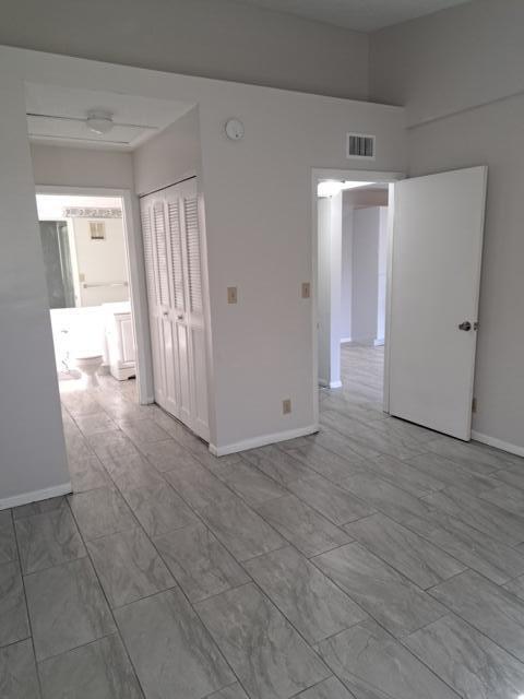 701 Lyons Road, Unit 13208 Coconut Creek, FL 33063 - Photo 17 of 31 a view of a hallway with wooden floor and cabinet