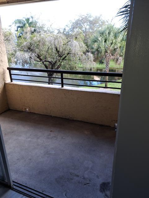 701 Lyons Road, Unit 13208 Coconut Creek, FL 33063 - Photo 20 of 31 a view of outdoor space and trees