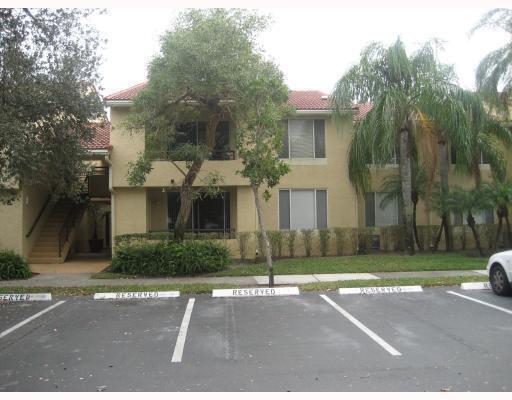 701 Lyons Road, Unit 13208 Coconut Creek, FL 33063 - Photo 2 of 31 a front view of a house with a yard