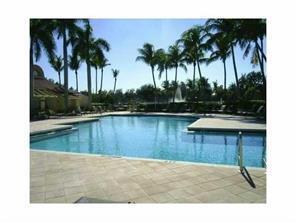 701 Lyons Road, Unit 13208 Coconut Creek, FL 33063 - Photo 22 of 31 a swimming pool with a table and palm trees