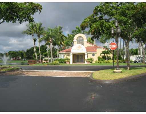 701 Lyons Road, Unit 13208 Coconut Creek, FL 33063 - Photo 23 of 31 a front view of a house with a yard and garage