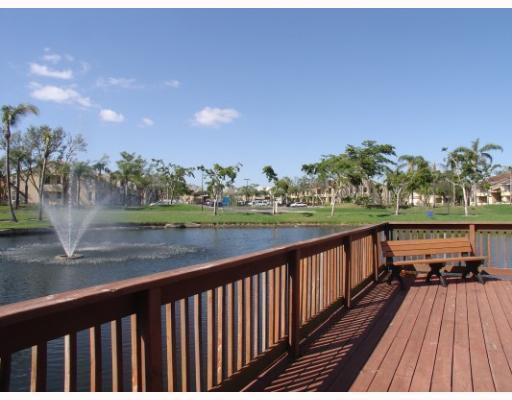 701 Lyons Road, Unit 13208 Coconut Creek, FL 33063 - Photo 26 of 31 a view of balcony with wooden floor and outdoor space