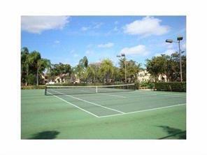 701 Lyons Road, Unit 13208 Coconut Creek, FL 33063 - Photo 30 of 31 a view of a tennis court