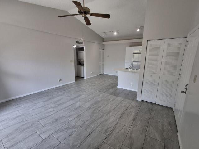 701 Lyons Road, Unit 13208 Coconut Creek, FL 33063 - Photo 3 of 31 a view of empty room with wooden floor