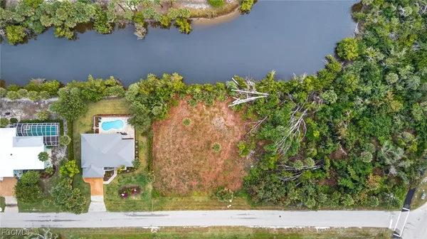 an aerial view of a house with a yard and garden