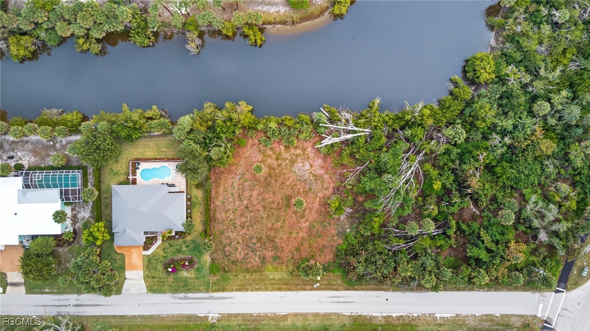 3304 St Kilda Road Sanibel, FL 33957 - Photo 13 of 23 an aerial view of a house with a yard and garden